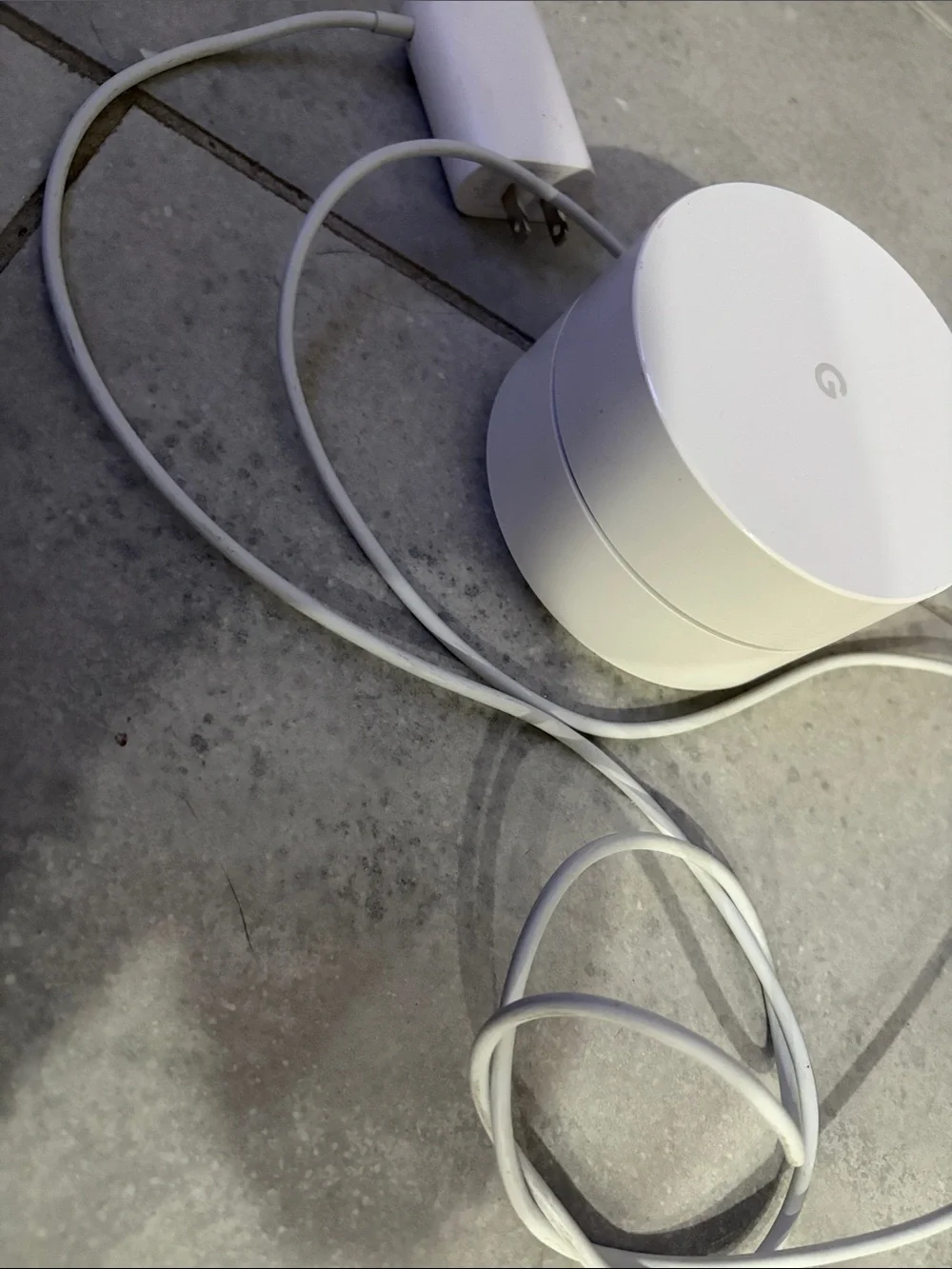 Google mesh Wi‑Fi puck in white with blue LED